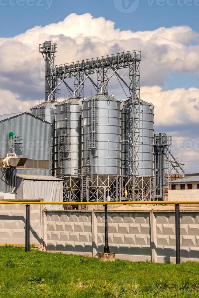 panorama view on agro silos granary elevator on agro-processing manufacturing plant for processing drying cleaning and storage of agricultural products, flour, cereals and grain. photo
