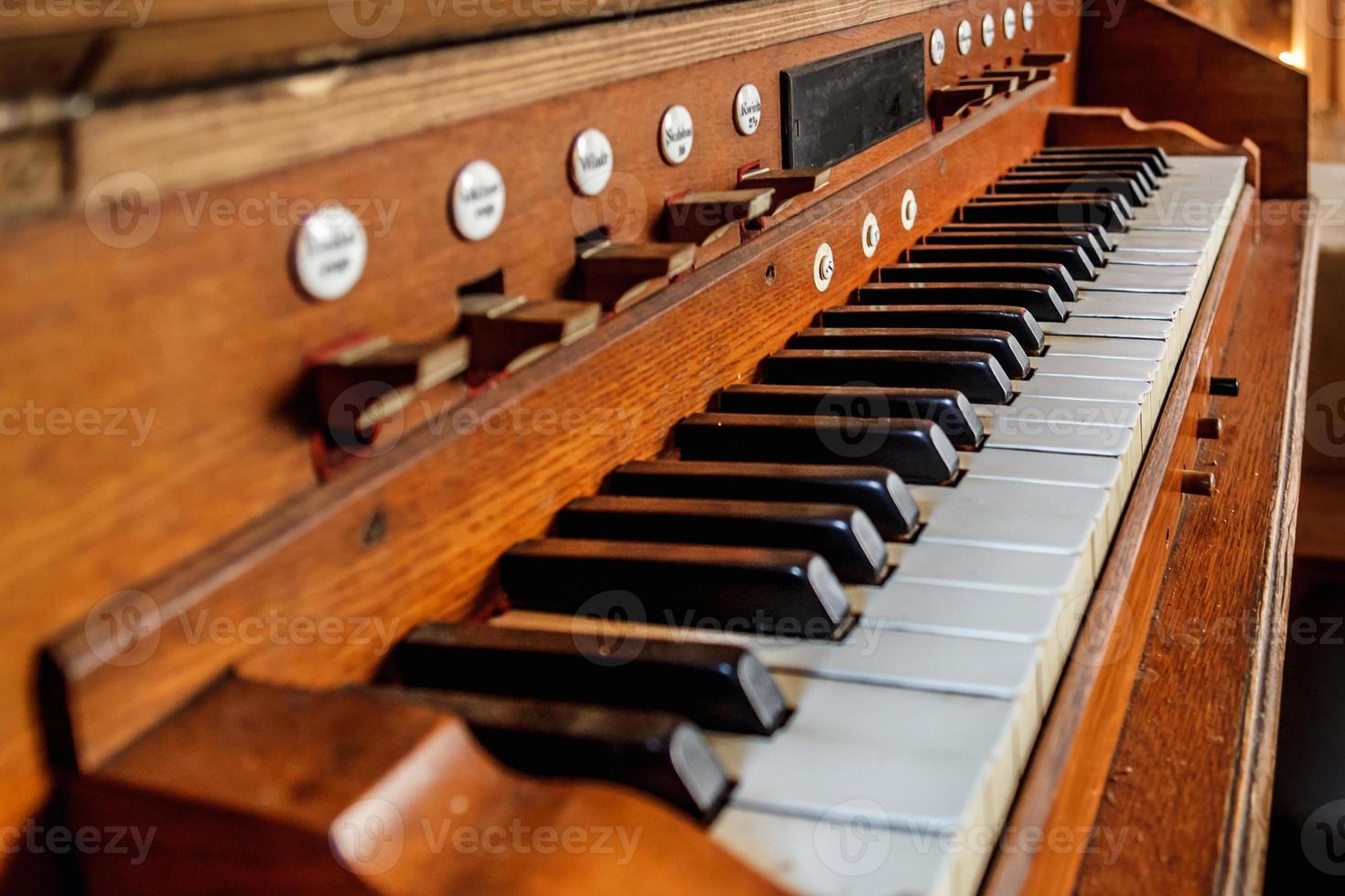 Vintage background with old scratched dusty keys of an ancient organ photo