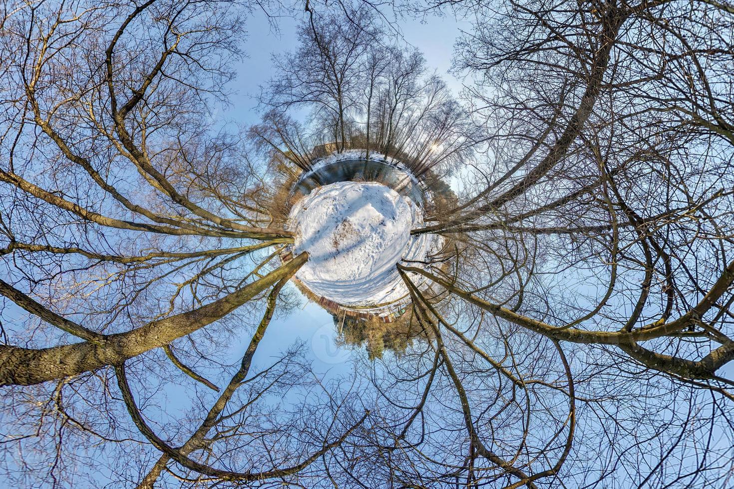 Little planet. Spherical aerial 360 panorama view in the winter forest in winter sunny day on blue background photo