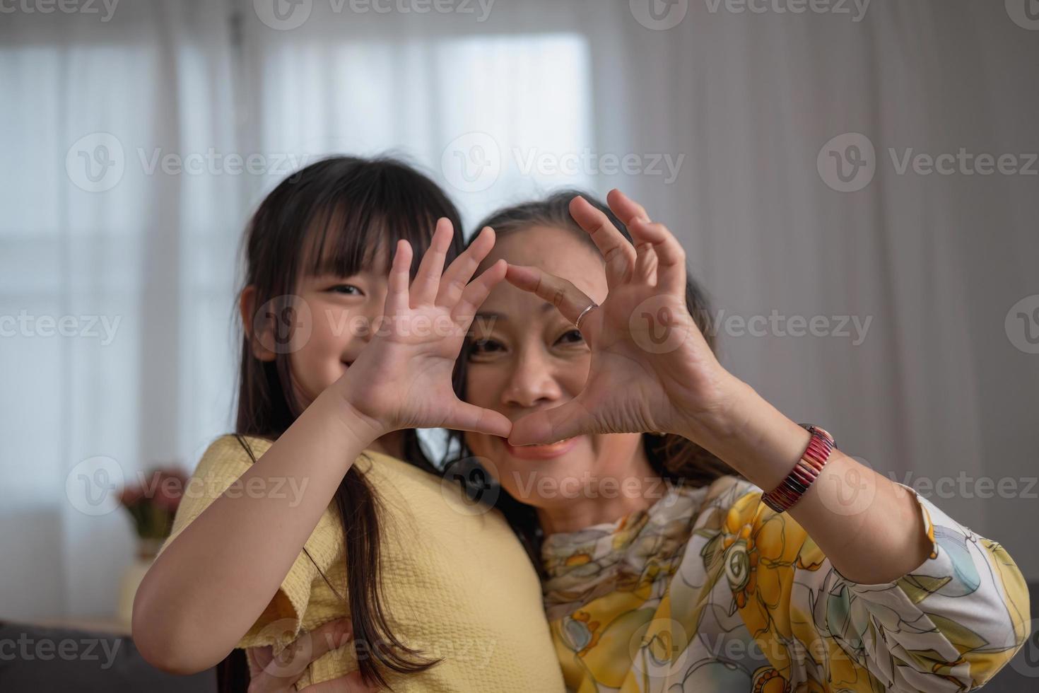 Portrait of a grandmother and granddaughter doing home activities and showing love for one another to create warmth and love within the family. photo