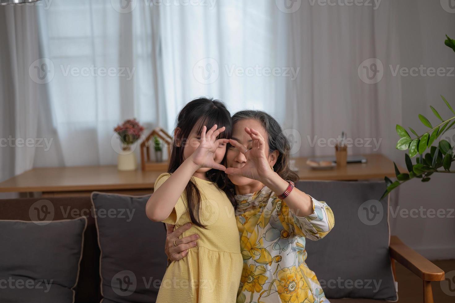 Portrait of a grandmother and granddaughter doing home activities and showing love for one another to create warmth and love within the family. photo