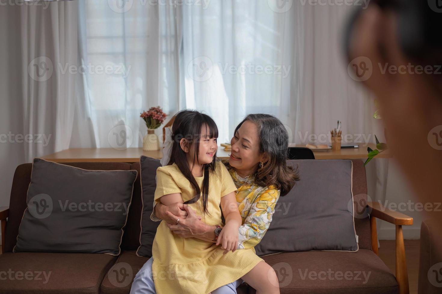 Portrait of an elderly woman and granddaughter hugging each other to show affection and family activities. photo