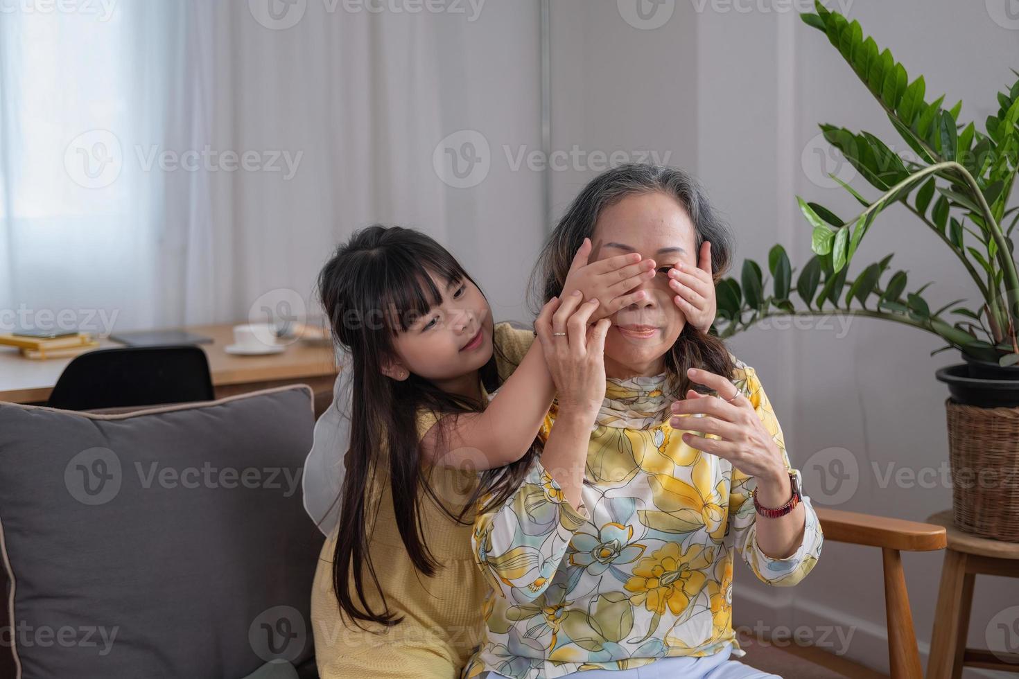 Portrait of a grandmother and granddaughter doing home activities and showing love for one another to create warmth and love within the family. photo