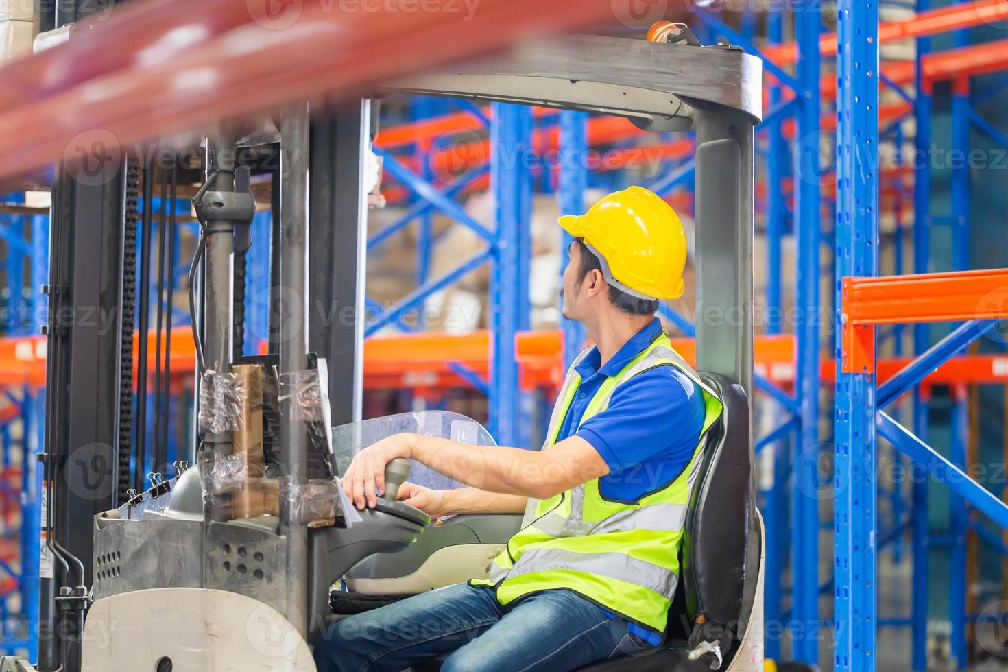 Worker on forklift, Manual workers working in warehouse, Worker driver at warehouse forklift loader works photo