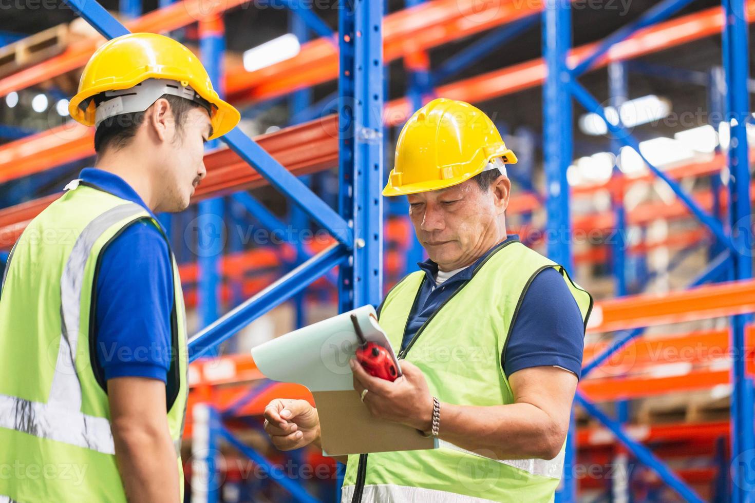 Workers team taking inventory in factory warehouse, Manual workers working in warehouse talking
