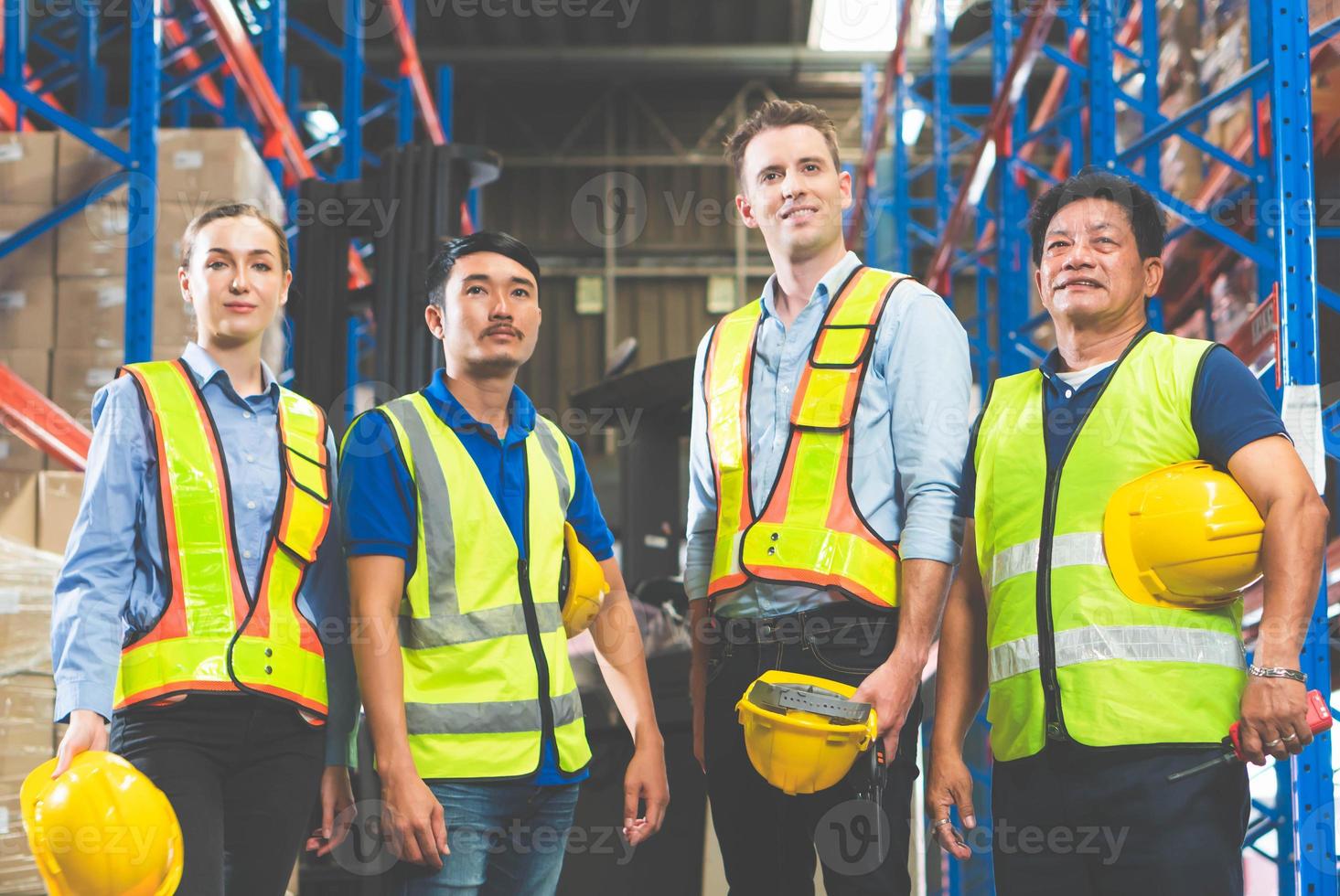 Portrait of successful logistics warehouse workers team, Group portrait of industry workers, Workers in hardhat helmet at workplace photo