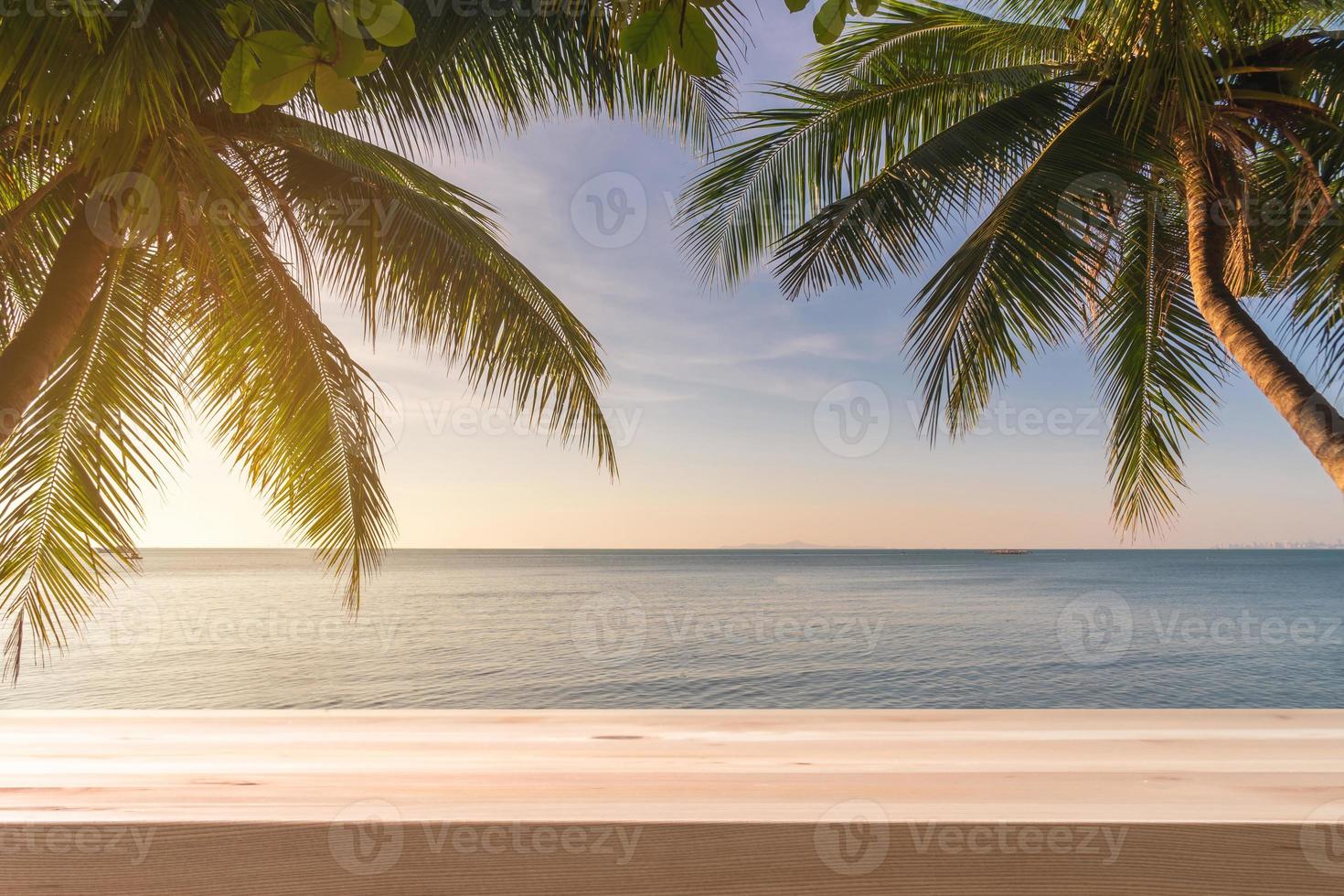 Empty table top with coconut palm tree and blue sky at tropical beach, Summer vacation concept photo