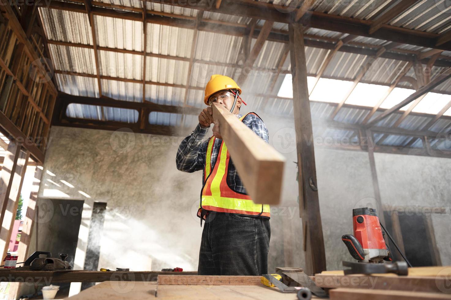 Carpenter working in an Asian carpentry office working portrait of a white man. photo