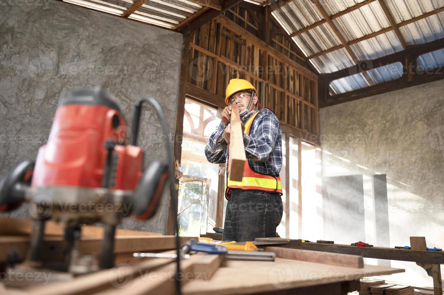 Carpenter working in an Asian carpentry office working portrait of a white man. photo