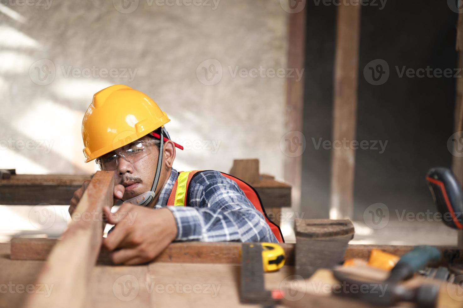 Carpenter working in an Asian carpentry office working portrait of a white man. photo