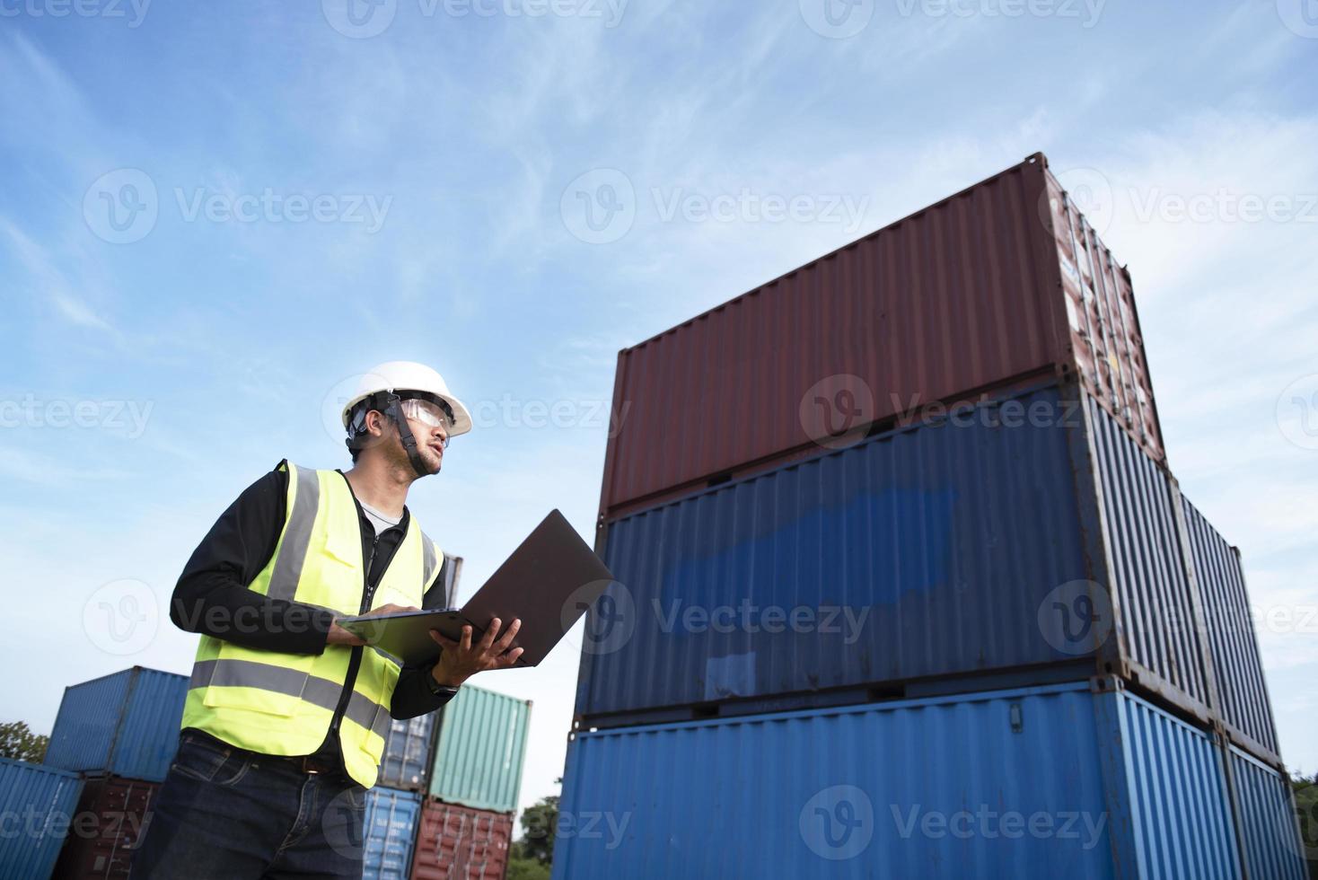 Foreman controls the loading of containers from cargo ships for import and export,Foreman or Supervisor in Container Terminal. photo