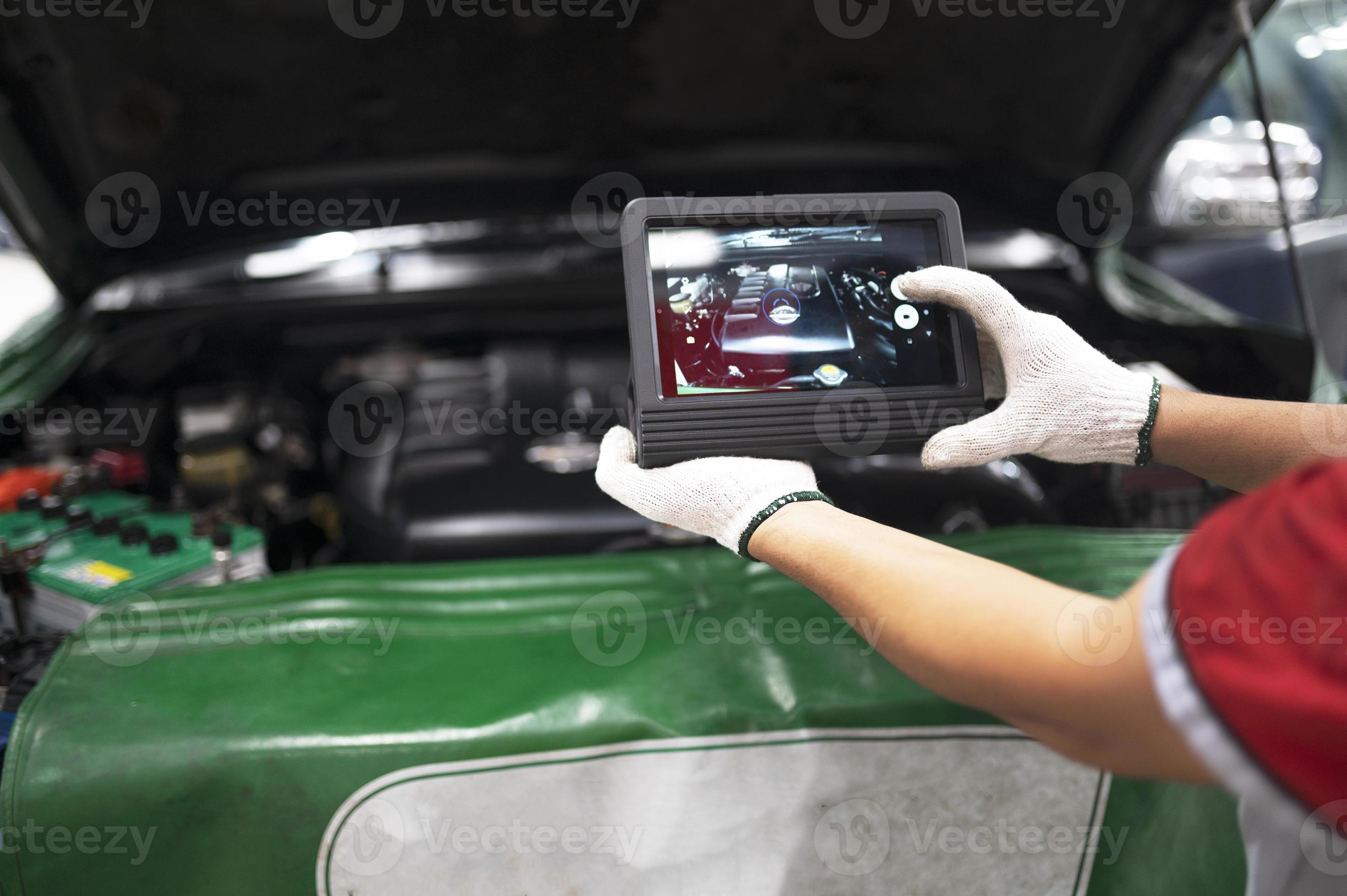 Professional mechanic and check car engine with computer diagnostic