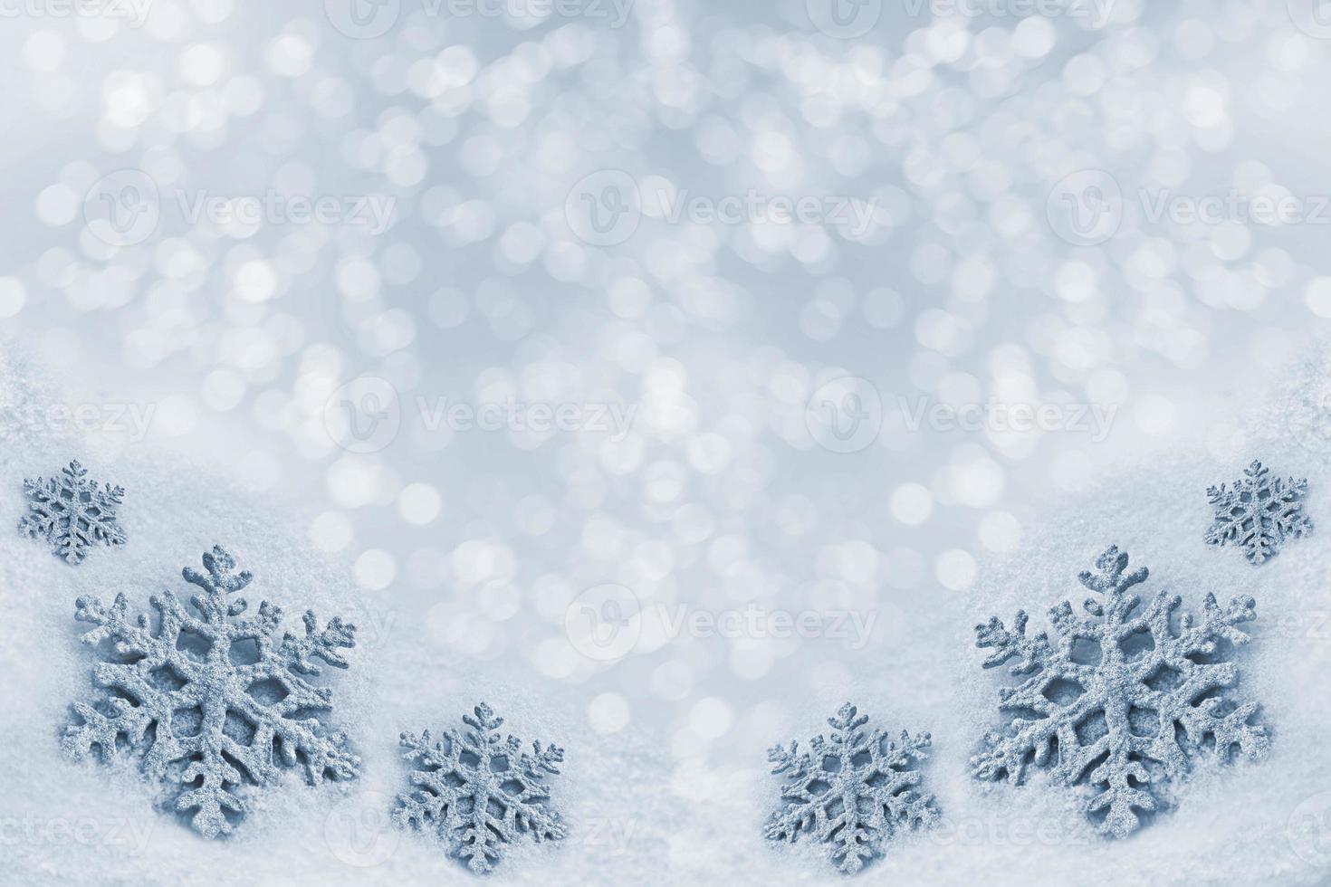 Glass toy snowflake on snow background. photo