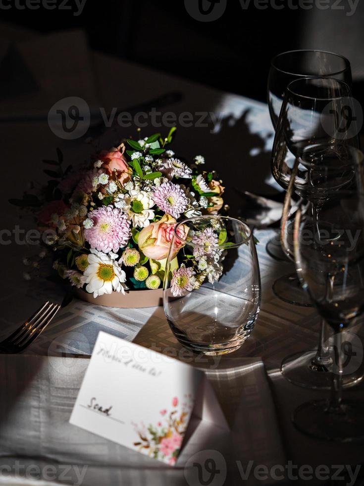 Wedding table decorations. Flowers, figurines of the bride and groom. photo