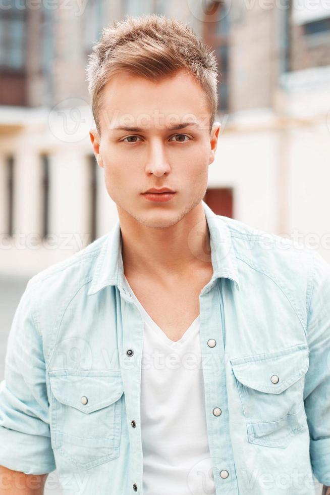 close-up portrait of a young man in jeans clothes photo