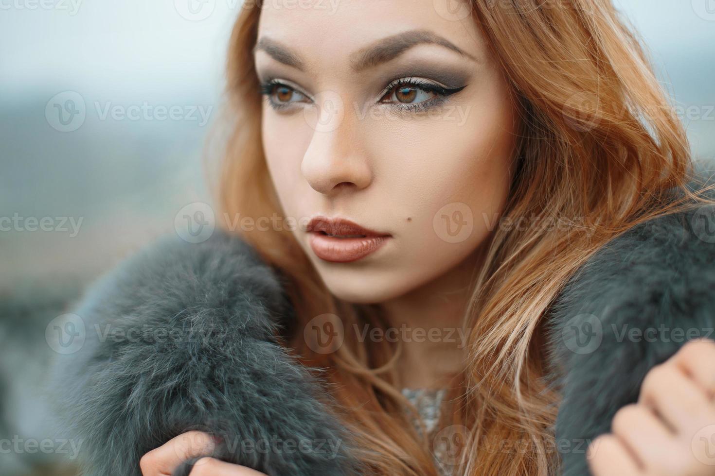 Beautiful girl in a fur jacket photo