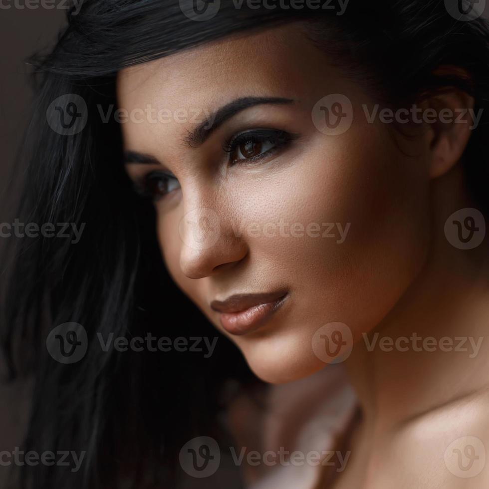 Portrait of a young beautiful brunettes, light from the window photo