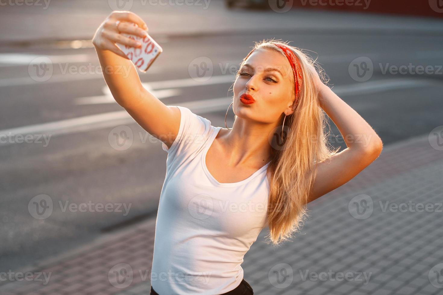 Pretty hipster girl taking selfie and making duck face. Sending kisses. Instagram photo