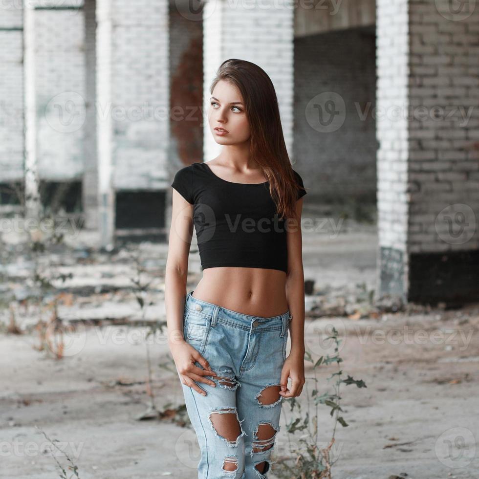 Beautiful portrait of a pretty woman on the ruins of the bricks photo