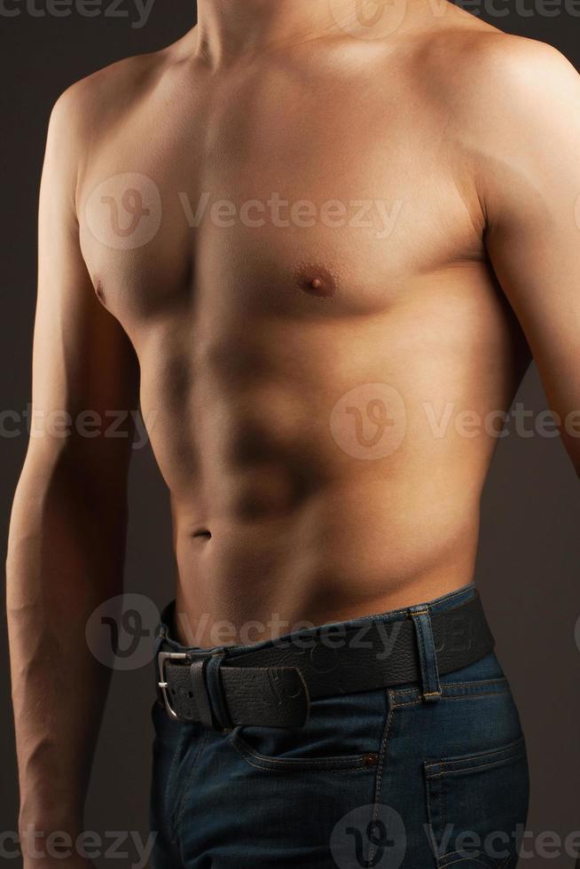 Abdominal muscles and chest. Athlete in the studio. 9856656 Stock Photo