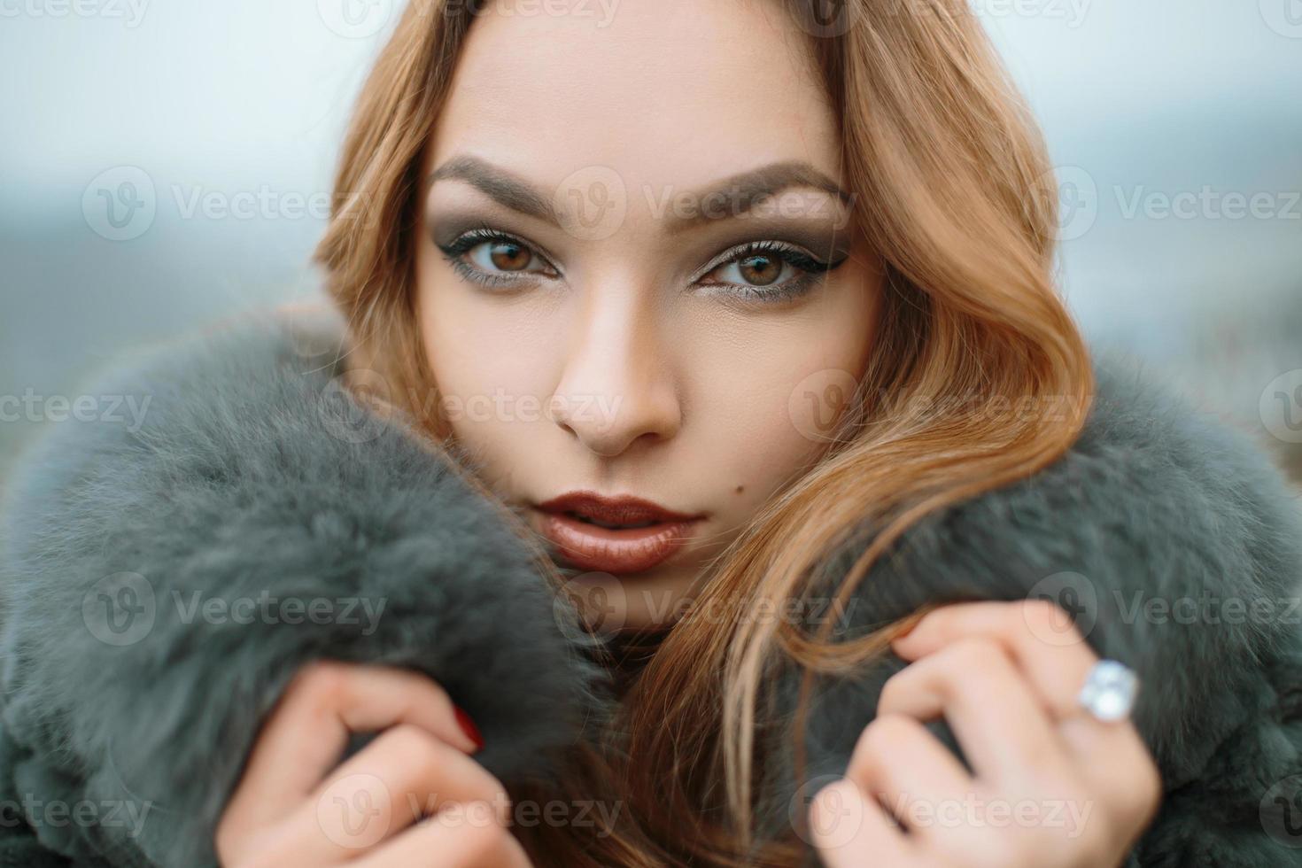 Stylish beautiful girl on the background of the foggy autumn day photo