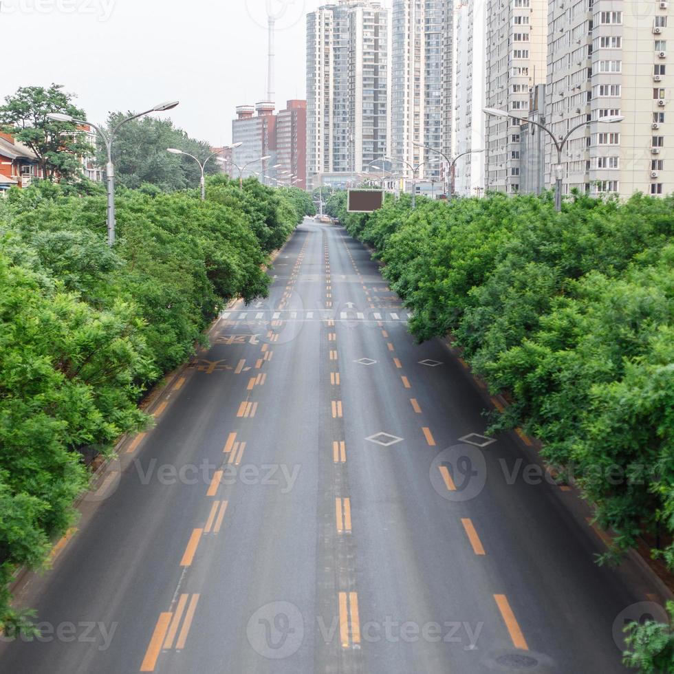Road with a marking. The track on the background of the city and trees. photo