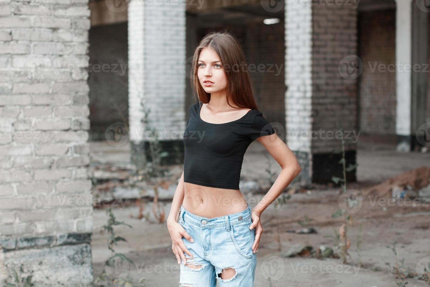Beauty woman with fashion casual clothes in blue torn jeans on the street photo