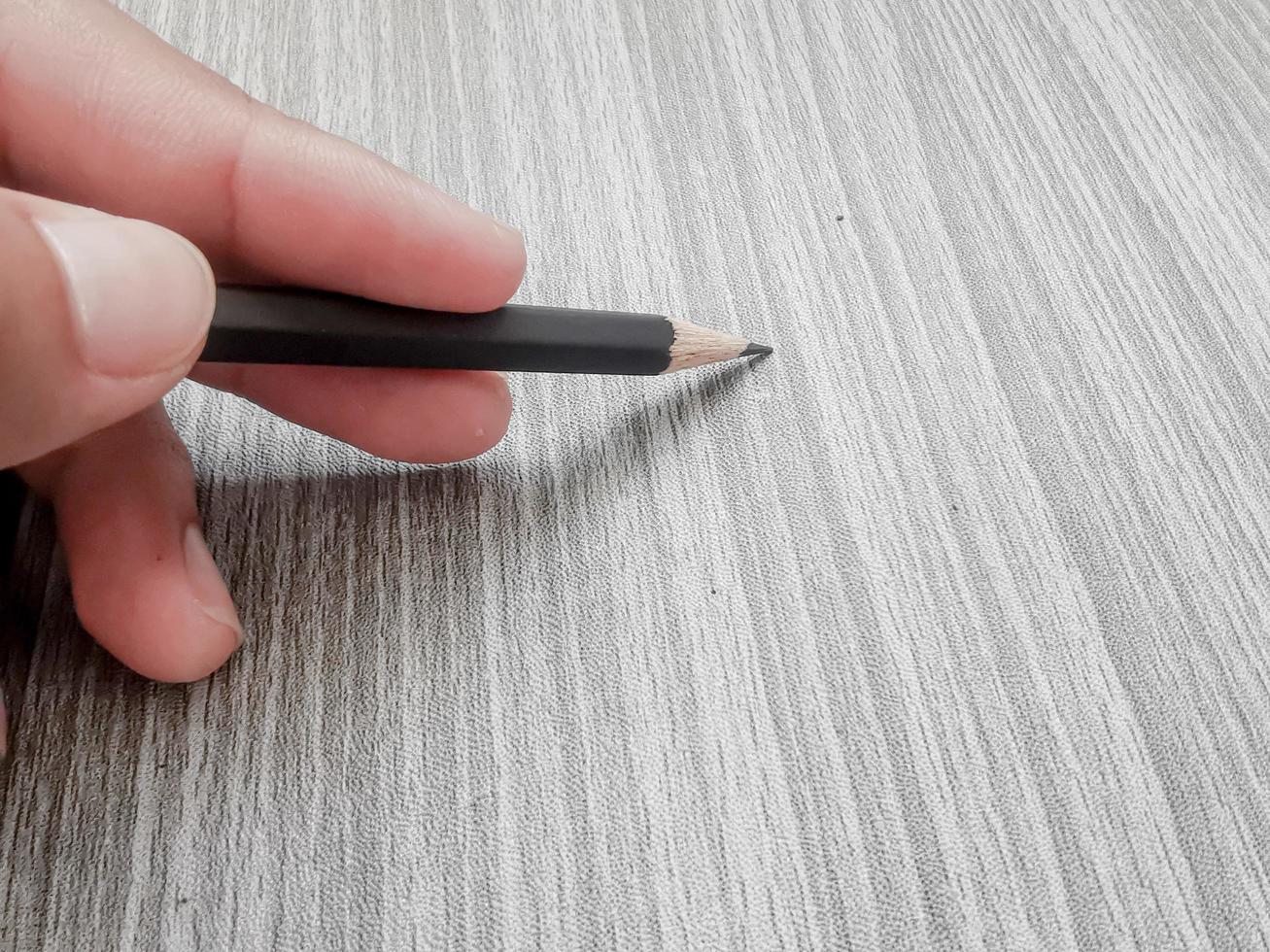 hand holding a pencil writing photo