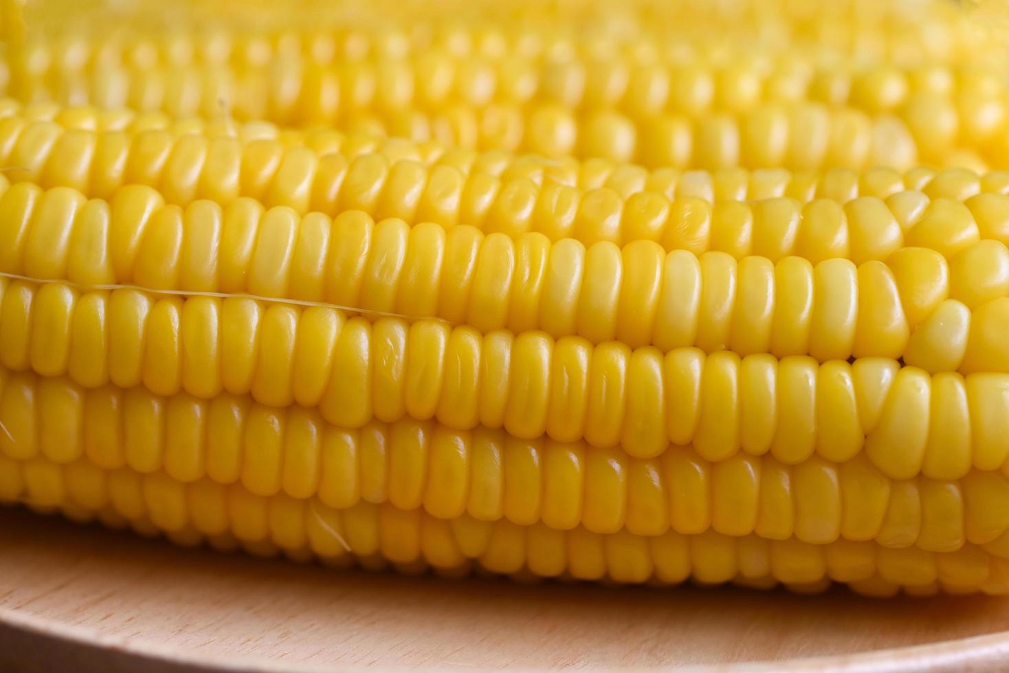 ripe corn cobs steamed or boiled sweetcorn for food vegan dinner or snack, cooked sweet corn background photo