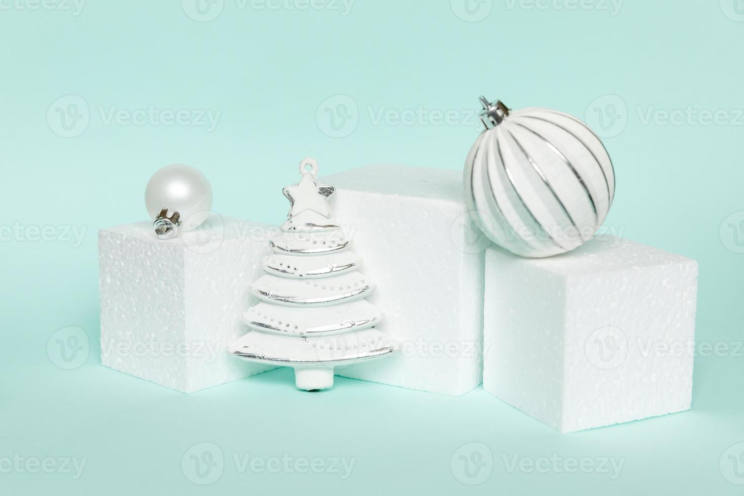 Simply minimal composition winter objects ornament and cube shapes geometric form podium isolated blue pastel background. Christmas New Year december time for celebration concept. Mockup, copy space photo