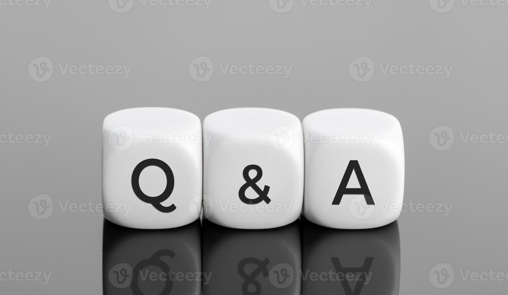 Q and A or questions and answers concept. White blocks shape with text on desk. Copy space photo