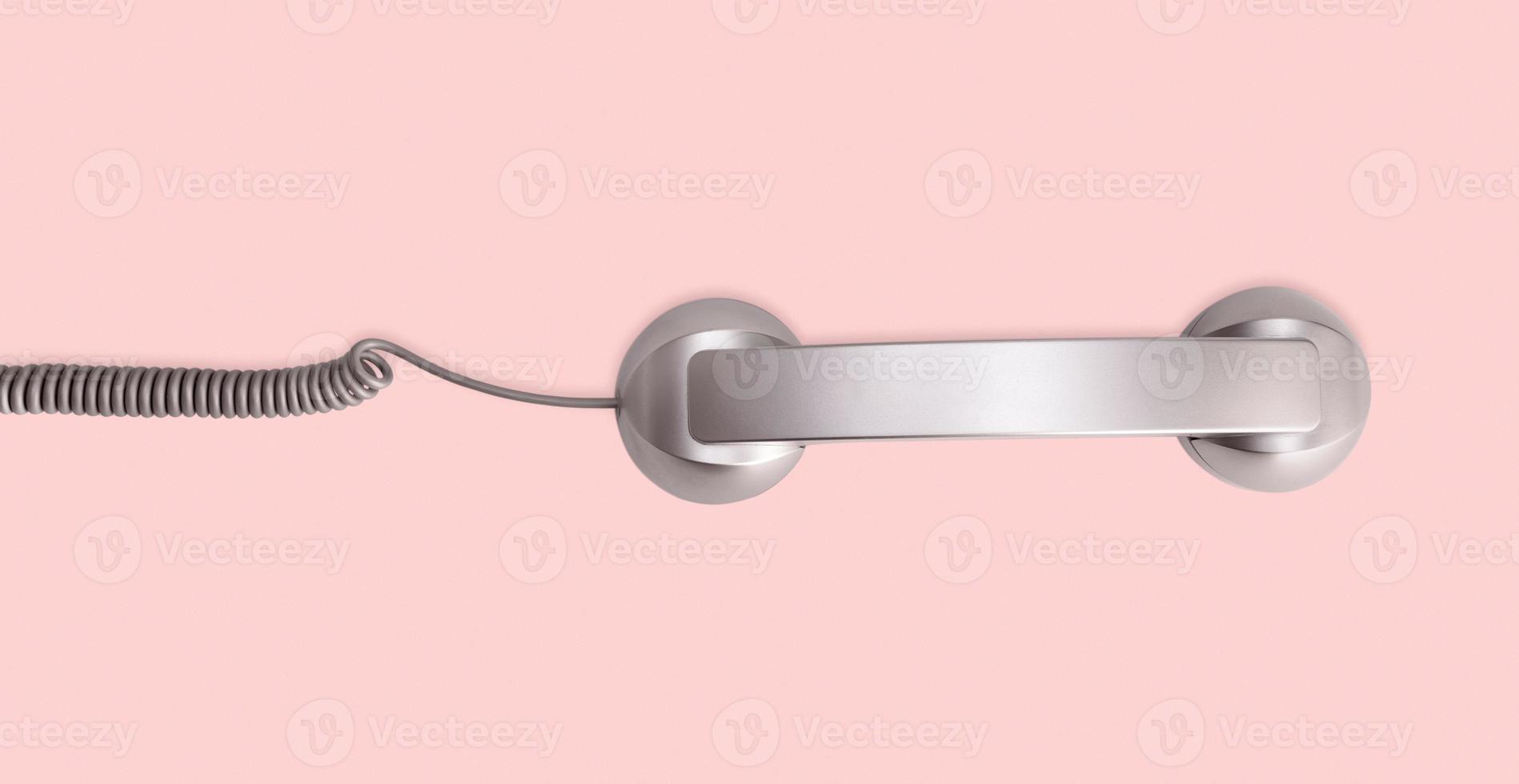 Telephone handset isolated on pink background. Contact us banner. Top view photo