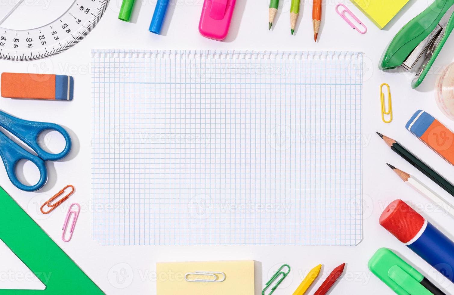 Blank graph paper sheet and School and office supplies around. Back to school background. Flat lay template mock up photo