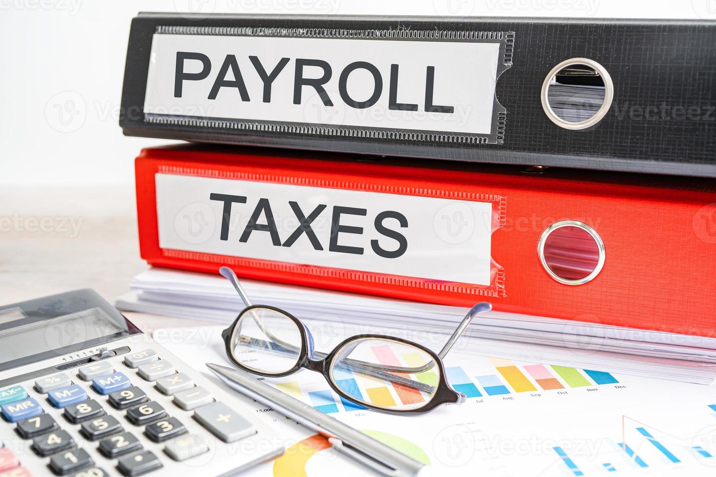 Payroll taxes. Binder data finance report business with graph analysis in office. photo