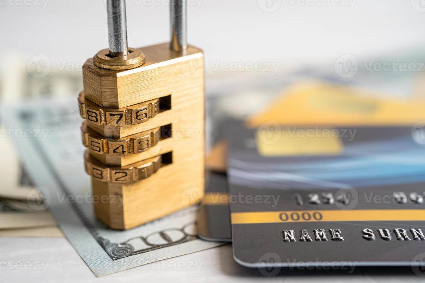 Credit card with password key lock security on US dollar background. photo