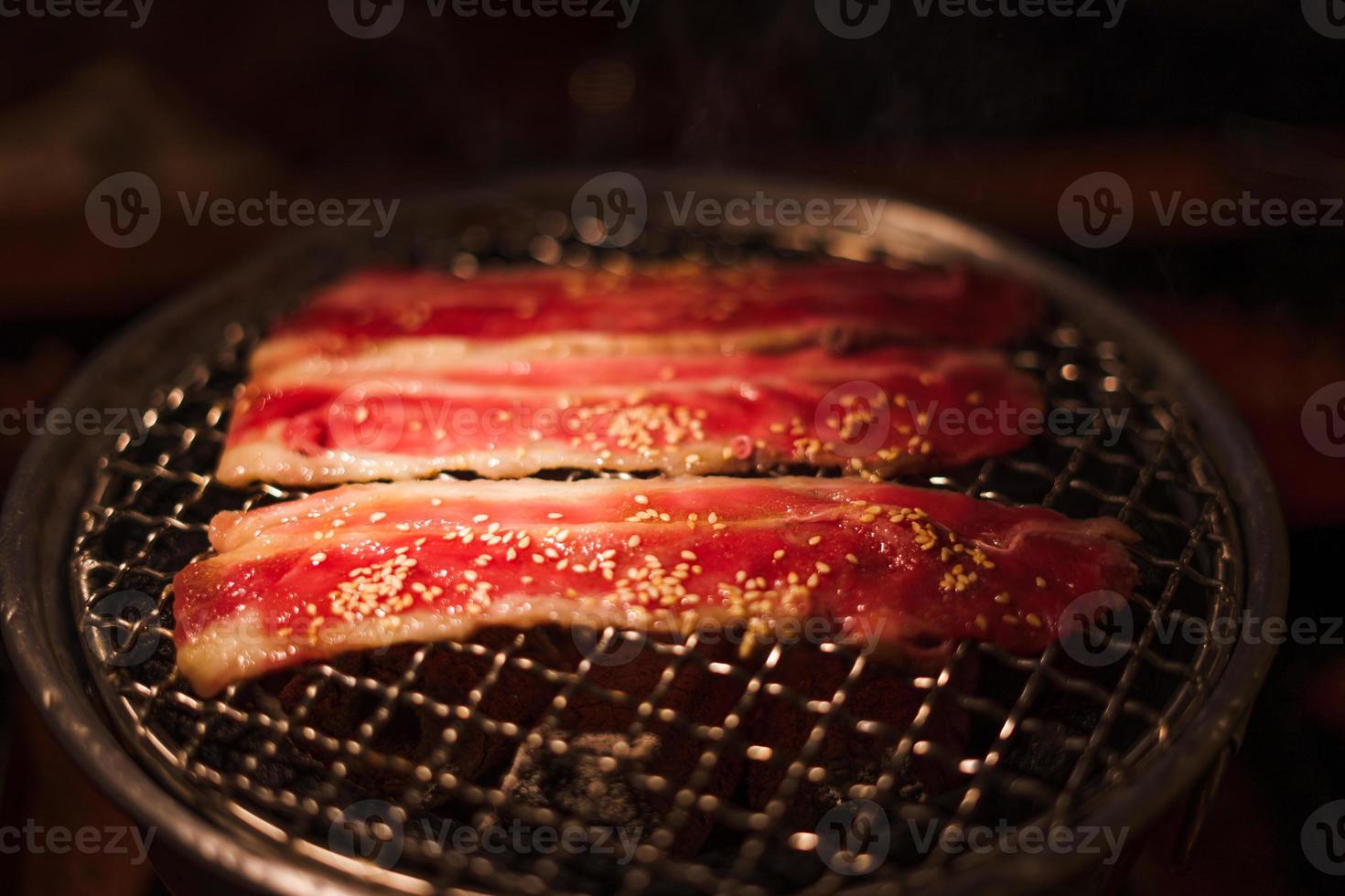 Grilling wagyu beef on charcoal grill photo