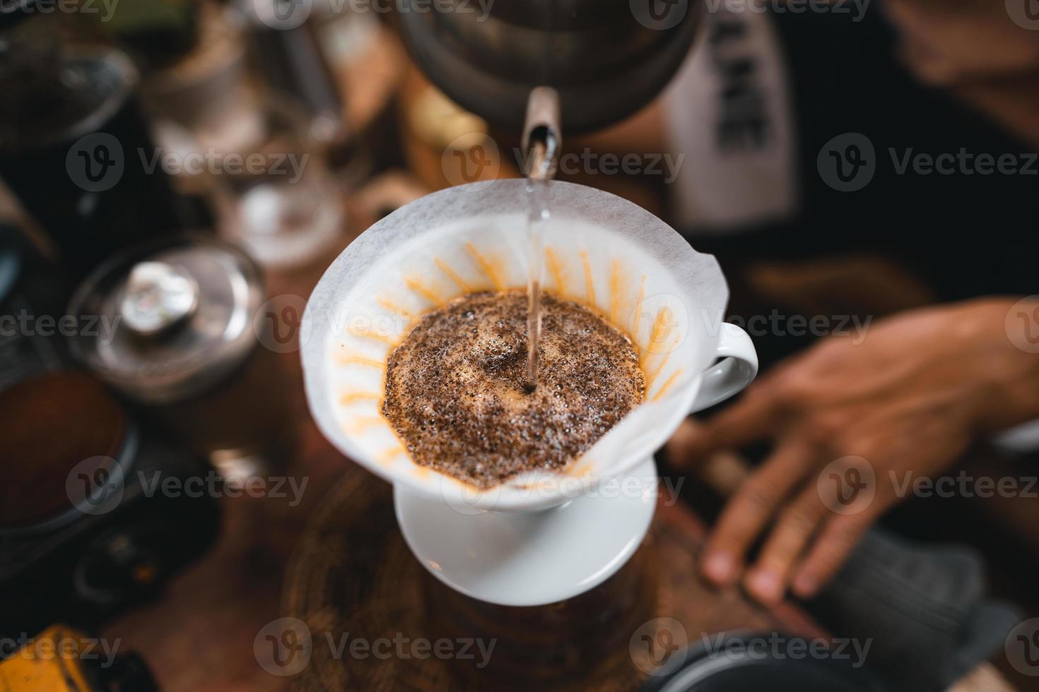 Closeup of hands barista make coffee photo
