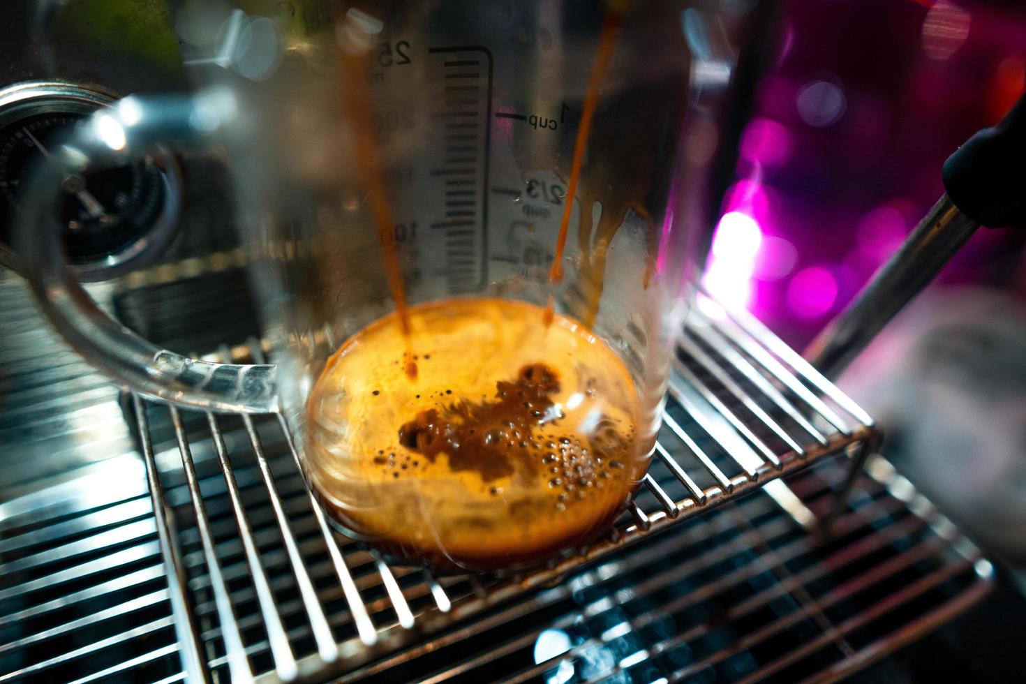 Expresso coffee dripping from the machine photo