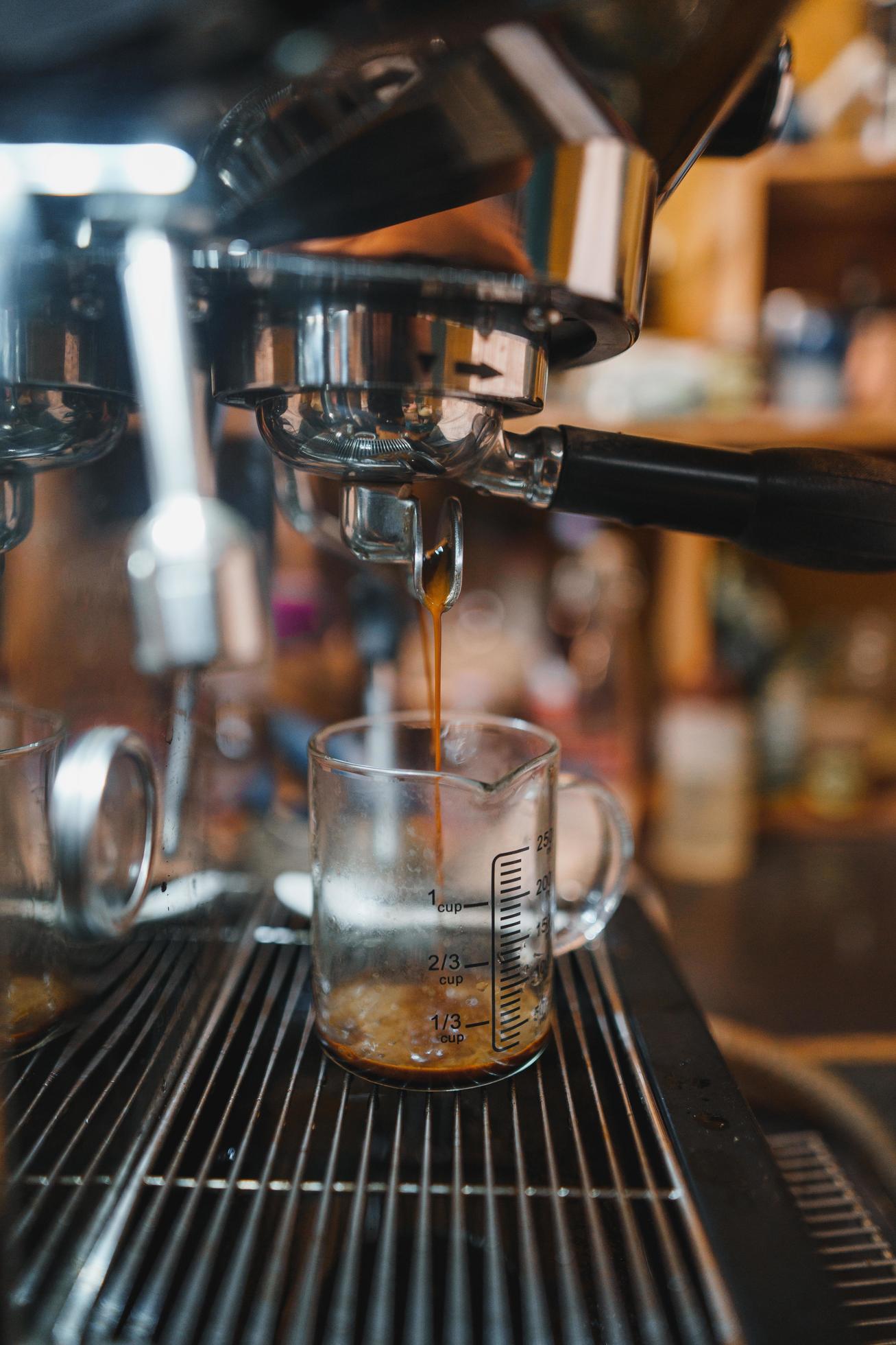Expresso coffee dripping from the machine 9884939 Stock Photo at Vecteezy