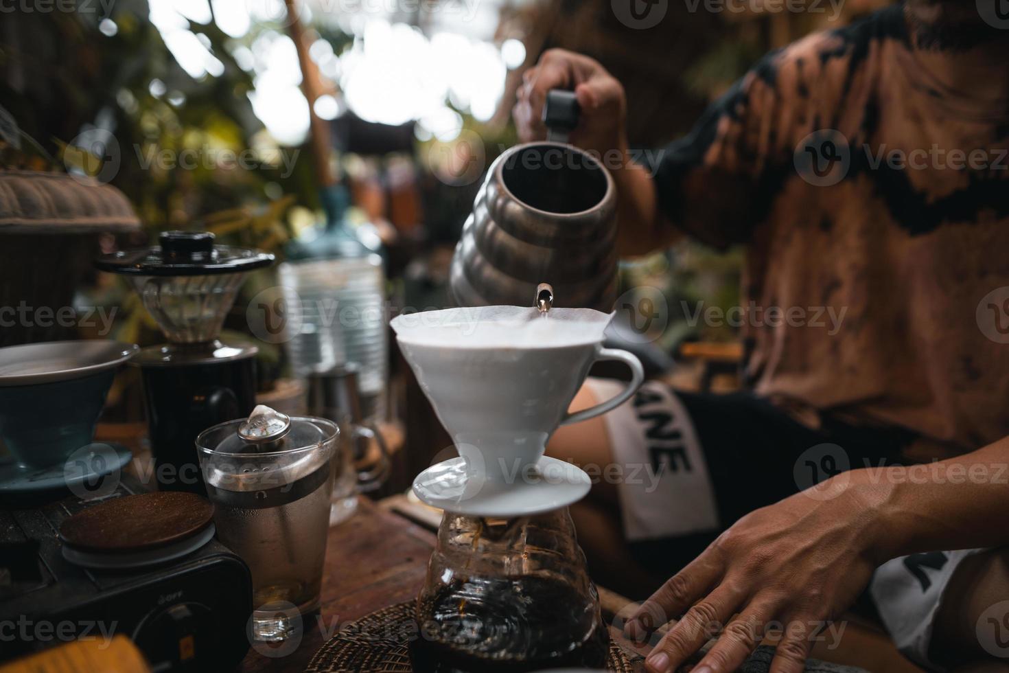 Closeup of hands barista make coffee photo