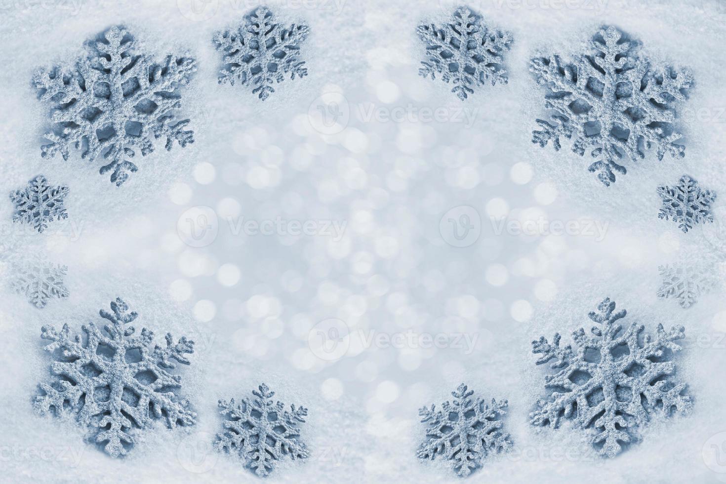 Glass toy snowflake on snow background. photo