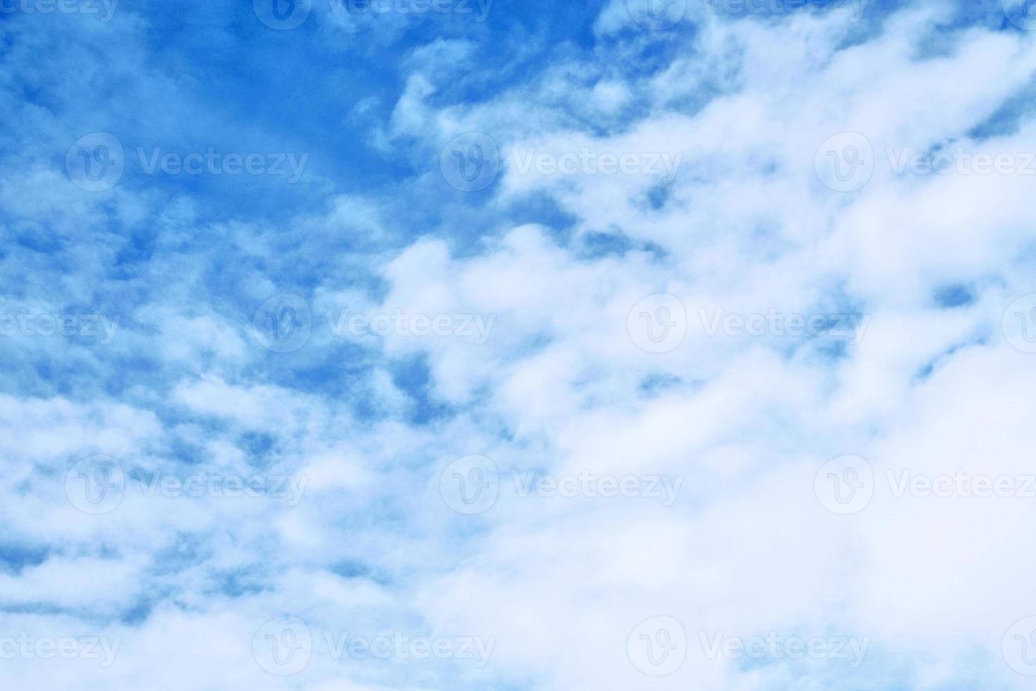 Blurred background. Blue sky and white fluffy clouds. photo