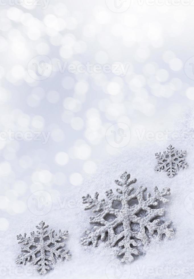 Glass toy snowflake on snow background. photo