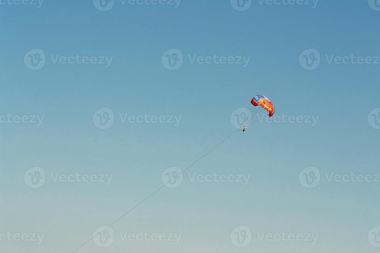 Leap of a man with a parachute photo