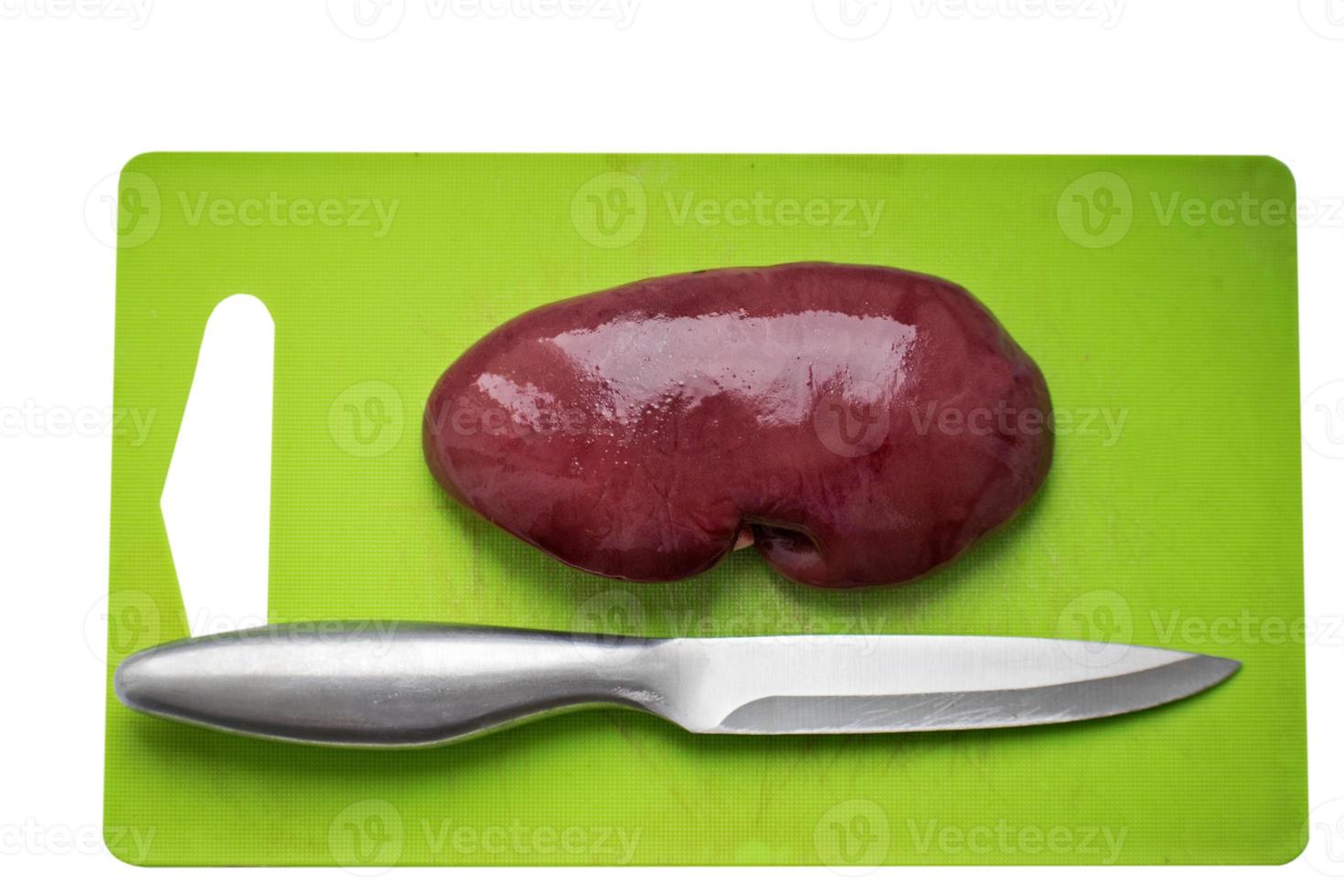 Fresh pork kidney on a cutting board. Fresh raw kidney for dog. photo