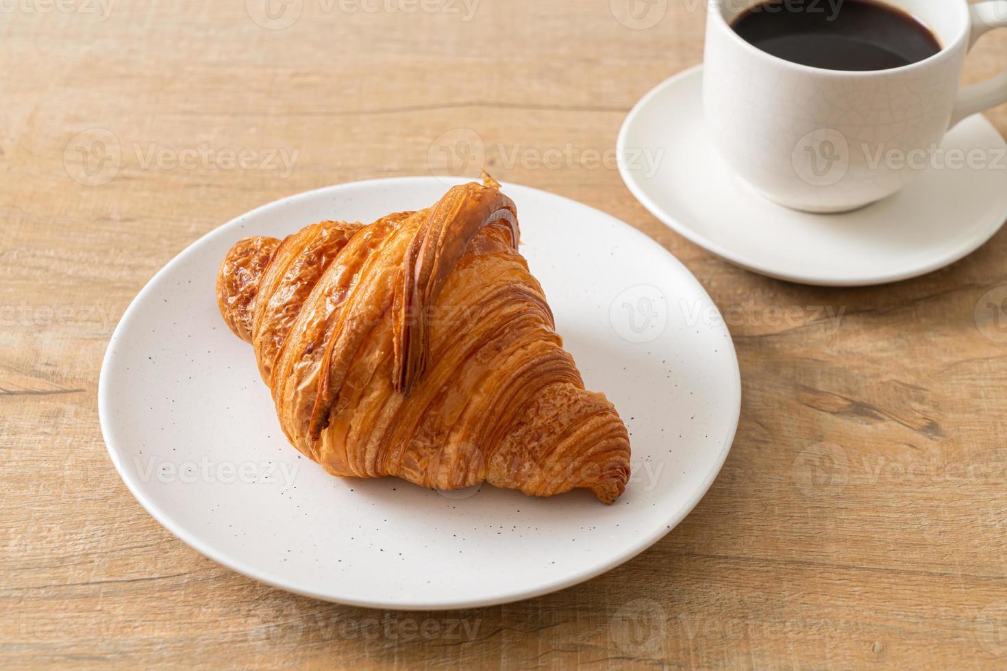 fresh croissant on white plate photo