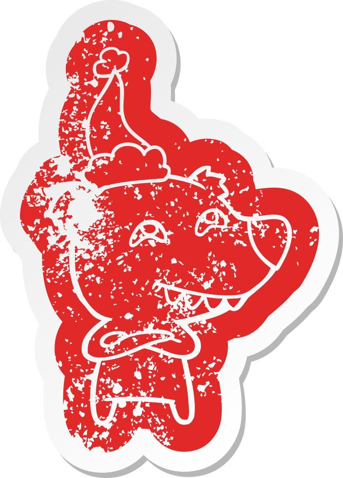 cartoon distressed sticker of a bear showing teeth wearing santa hat vector