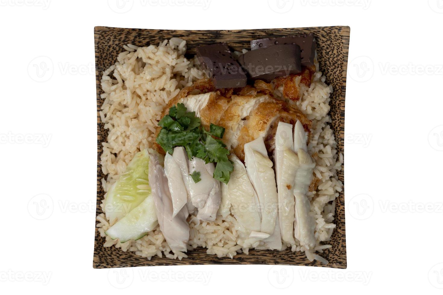 Above view of Hainanese chicken glutinous rice mix with Fried Chicken. Served in a coconut-patterned dish. Isolate white background with clipping path. photo