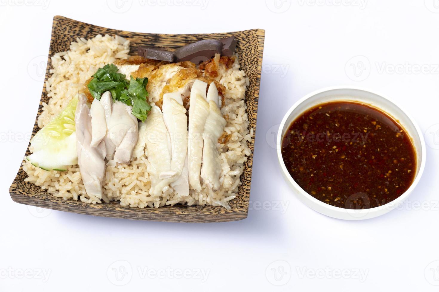 Hainanese chicken glutinous rice mix with Fried Chicken and sauce. Served in a coconut-patterned dish. On white floor or isolated white background. photo