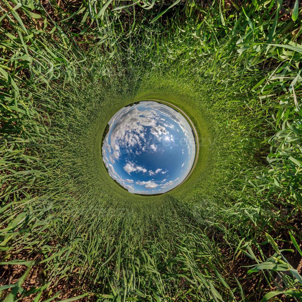 blue sphere little planet inside gravel road or field background. photo